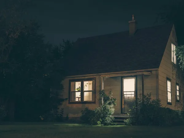 A Vancouver Island home with warm, properly wired interior and exterior lighting at dusk